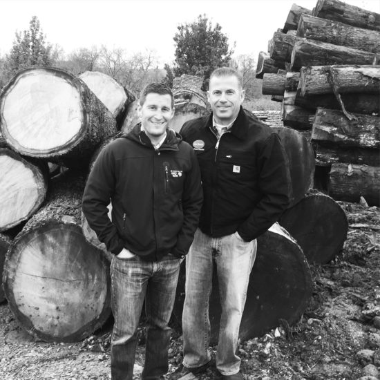 Team Members in front of logs